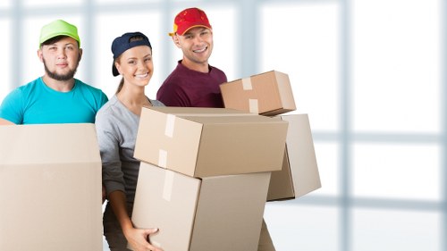 A local removals team carrying furniture during a Richmond house move