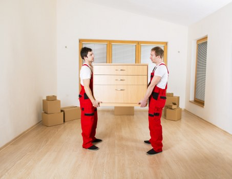 Removalists navigating a Richmond property with furniture and moving equipment