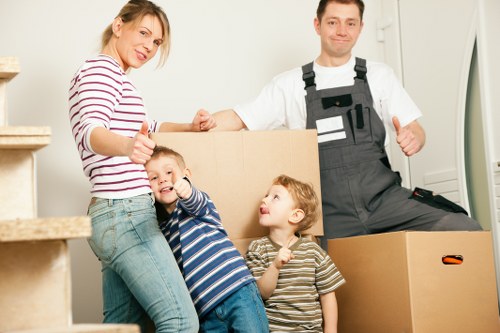 Local movers organizing furniture and boxes during relocation